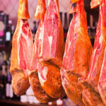 Traditional Spanish Serrano Schinken sliced and served with cheese and wine