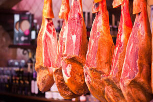 Traditional Spanish Serrano Schinken sliced and served with cheese and wine